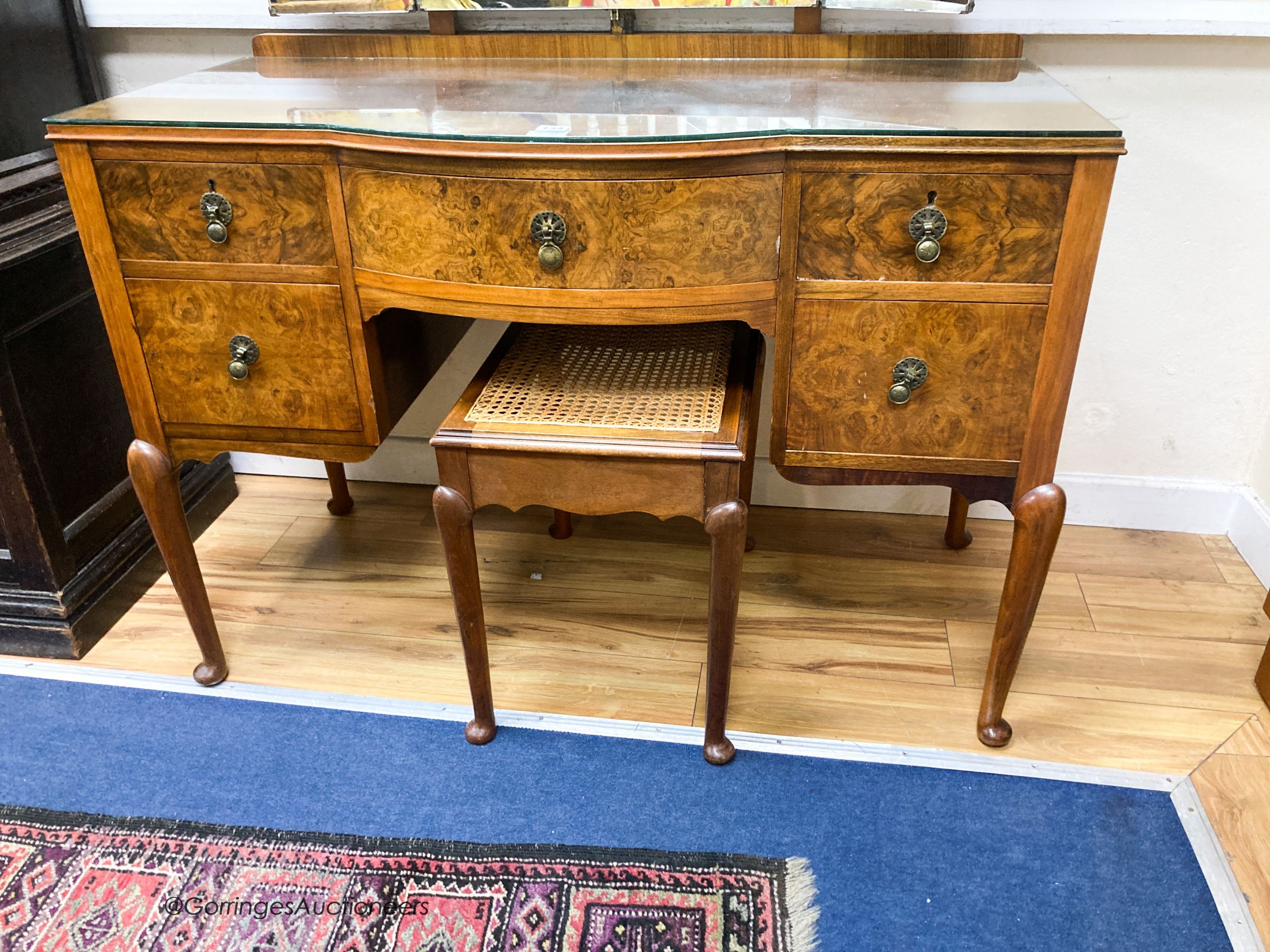 A 1930’s burr walnut dressing table, width 114cm, depth 52cm, height 160cm and a cane topped stool (2)